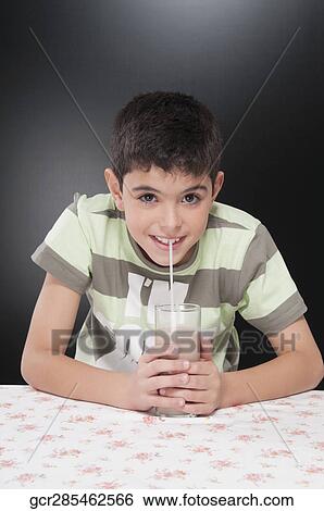 Boy drinking chocolate milkshake and smiling View Large Photo Image Stock Photograph - Boy drinking chocolate milkshake and smiling. Fotosearch