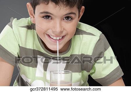 Boy drinking chocolate milkshake and smiling View Large Photo Image Stock Photography - Boy drinking chocolate milkshake and smiling. Fotosearch