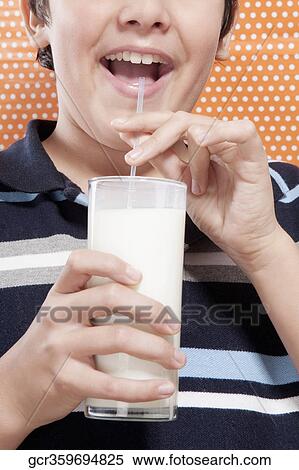 Boy drinking milk with a straw View Large Photo Image Stock Photography - Boy drinking milk with a straw. Fotosearch