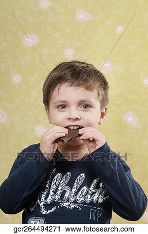 Boy eating a chocolate bar View Large Photo Image Stock Image - Boy eating a chocolate bar. Fotosearch