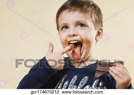Boy eating a chocolate View Large Photo Image Stock Image - Boy eating a chocolate. Fotosearch