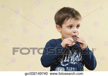 Boy eating a chocolate View Large Photo Image Stock Image - Boy eating a chocolate. Fotosearch