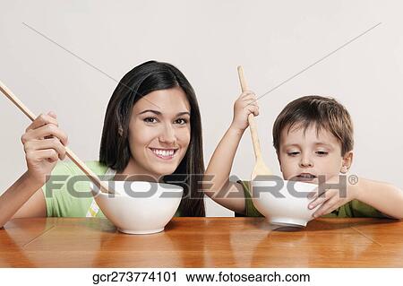 Boy helping his mother in cooking View Large Photo Image Stock Image - Boy helping his mother in cooking. Fotosearch