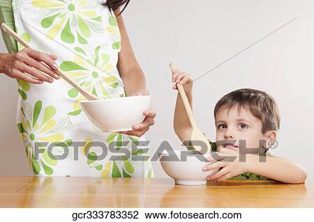 Boy helping his mother in cooking View Large Photo Image Stock Image - Boy helping his mother in cooking. Fotosearch
