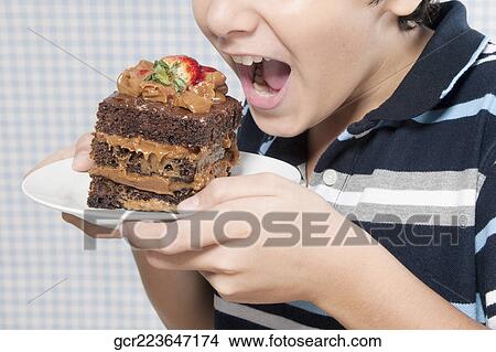 Boy holding a chocolate cake View Large Photo Image Picture - Boy holding a chocolate cake. Fotosearch