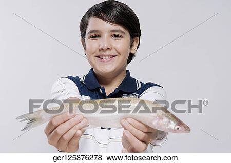 Boy holding a fish View Large Photo Image Stock Photo - Boy holding a fish. Fotosearch