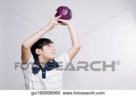 Boy holding a red cabbage View Large Photo Image Stock Image - Boy holding a red cabbage. Fotosearch