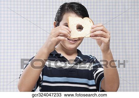 Boy holding a slice of bread View Large Photo Image Stock Image - Boy holding a slice of bread. Fotosearch