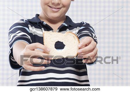 Stock Photo - Boy holding a slice of bread. Fotosearch