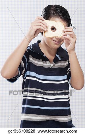 Boy holding a slice of bread View Large Photo Image Stock Photo - Boy holding a slice of bread. Fotosearch