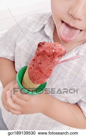 Boy licking an ice cream View Large Photo Image Stock Image - Boy licking an ice cream. Fotosearch