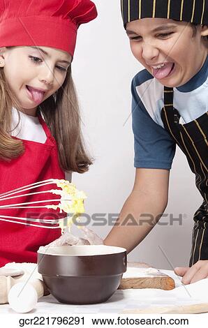 Boy with his sister looking with disgust at the raw mixture of cake View Large Photo Image Stock Image - Boy with his sister looking with disgust at the raw mixture of cake. Fotosearch