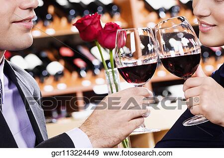 Business couple toasting with wine View Large Photo Image Stock Photo - Business couple toasting with wine. Fotosearch