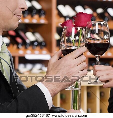 Business couple toasting with wine View Large Photo Image Stock Photo - Business couple toasting with wine. Fotosearch