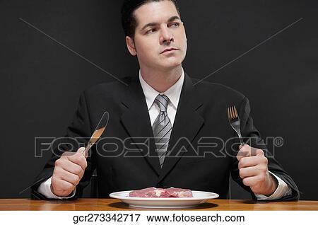 Stock Photo - Businessman at a dining table. Fotosearch