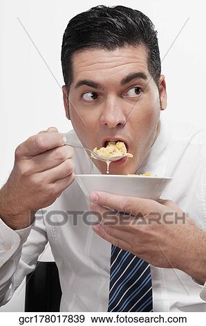 Businessman eating cereal View Large Photo Image Stock Photo - Businessman eating cereal. Fotosearch