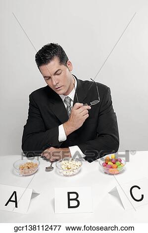 Businessman examining food samples View Large Photo Image Stock Photo - Businessman examining food samples. Fotosearch