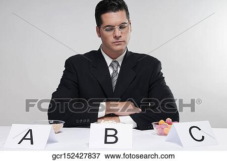 Businessman examining food samples View Large Photo Image Stock Photo - Businessman examining food samples. Fotosearch