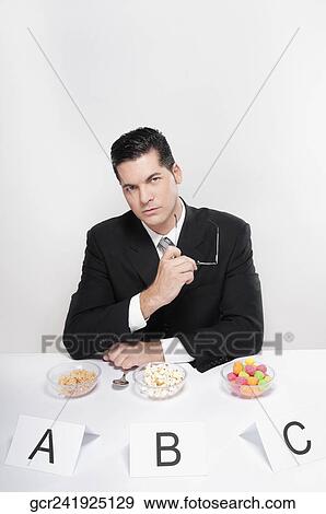 Businessman examining food samples View Large Photo Image Stock Photo - Businessman examining food samples. Fotosearch