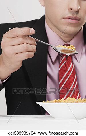 Businessman having breakfast View Large Photo Image Picture - Businessman having breakfast. Fotosearch
