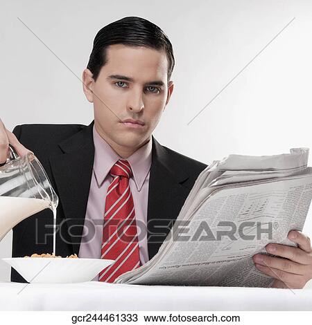 Stock Image - Businessman having breakfast. Fotosearch