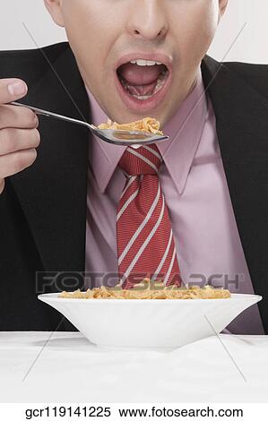Stock Photography - Businessman having breakfast. Fotosearch