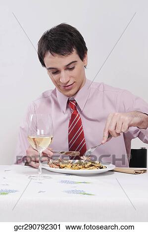 Businessman having lunch with white wine View Large Photo Image Stock Image - Businessman having lunch with white wine. Fotosearch
