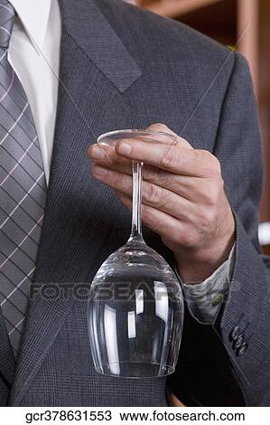 Stock Image - Businessman holding a wine glass. Fotosearch