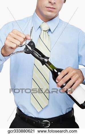 Businessman opening a bottle of wine View Large Photo Image Stock Image - Businessman opening a bottle of wine. Fotosearch