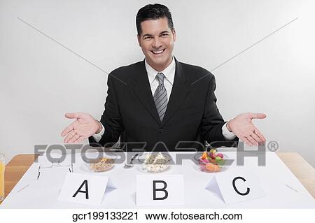 Businessman showing food samples View Large Photo Image Stock Image - Businessman showing food samples. Fotosearch