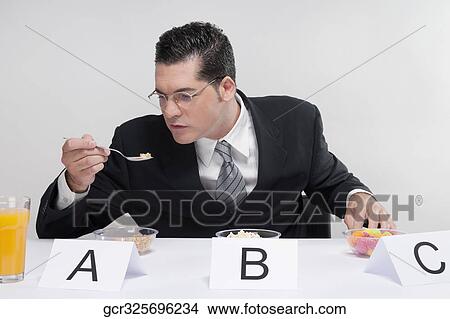 Businessman tasting food samples View Large Photo Image Picture - Businessman tasting food samples. Fotosearch