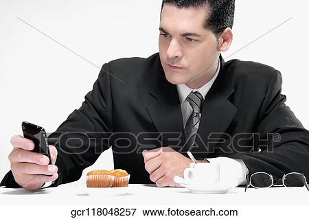 Businessman text messaging on a mobile phone View Large Photo Image Stock Photo - Businessman text messaging on a mobile phone. Fotosearch