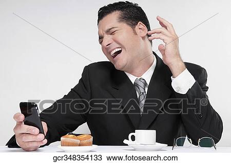 Stock Image - Businessman using a mobile phone. Fotosearch