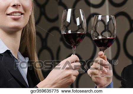 Businesswomen toasting with wine View Large Photo Image Stock Photography - Businesswomen toasting with wine. Fotosearch
