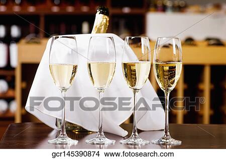 Champagne flutes on a table View Large Photo Image Picture - Champagne flutes on a table. Fotosearch