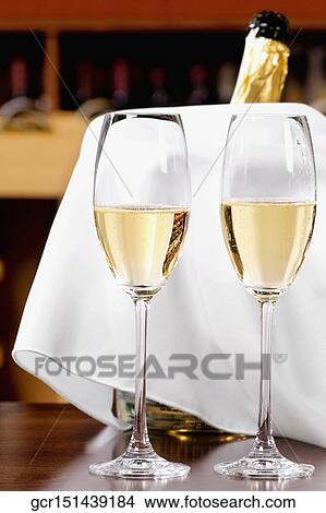 Champagne flutes on a table View Large Photo Image Picture - Champagne flutes on a table. Fotosearch