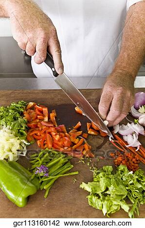 Chef chopping vegetables with a knife View Large Photo Image Stock Image - Chef chopping vegetables with a knife. Fotosearch