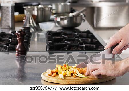 Chef chopping vegetables with a knife View Large Photo Image Stock Photo - Chef chopping vegetables with a knife. Fotosearch