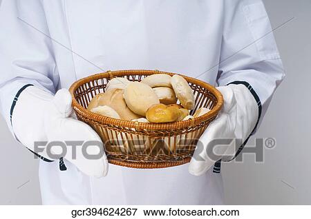 Chef holding a basket of buns View Large Photo Image Stock Photo - Chef holding a basket of buns. Fotosearch