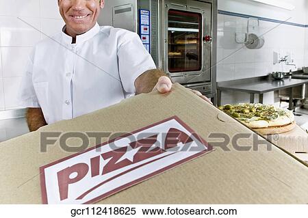 Chef holding a pizza box View Large Photo Image Stock Photography - Chef holding a pizza box. Fotosearch