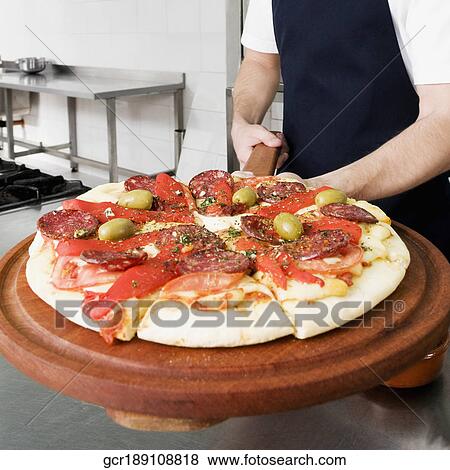 Chef preparing pizza in the kitchen View Large Photo Image Stock Photo - Chef preparing pizza in the kitchen. Fotosearch
