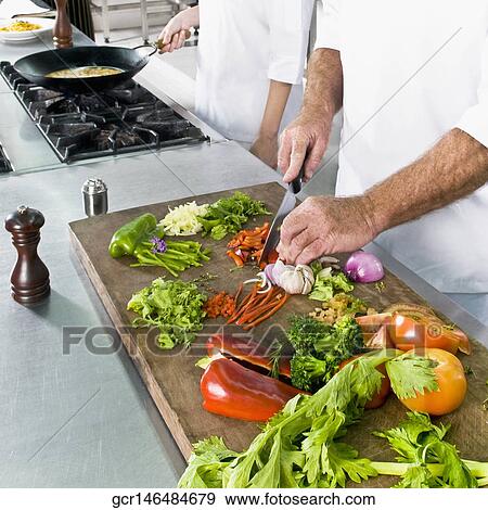 Chefs cooking food in the kitchen View Large Photo Image Stock Photo - Chefs cooking food in the kitchen. Fotosearch