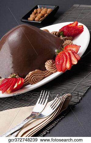 Stock Photo - Chocolate dessert served with strawberries. Fotosearch