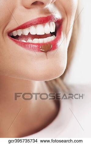 Chocolate drop on a woman's lip View Large Photo Image Picture - Chocolate drop on a woman's lip. Fotosearch