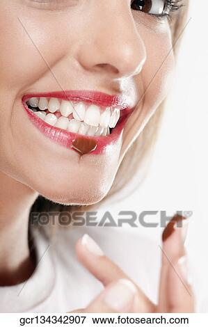 Stock Photo - Chocolate drop on a woman's lip. Fotosearch