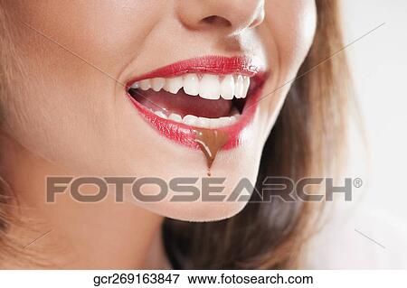 Chocolate drop on a woman's lip View Large Photo Image Stock Photo - Chocolate drop on a woman's lip. Fotosearch