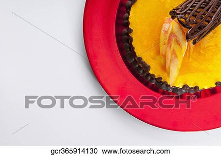 Stock Image - Chocolate garnish on a lemon flan cake. Fotosearch