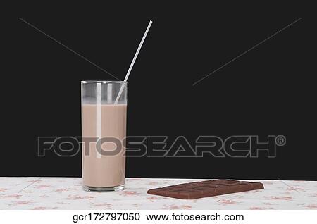 Chocolate milkshake with a chocolate bar on a table View Large Photo Image Stock Image - Chocolate milkshake with a chocolate bar on a table. Fotosearch
