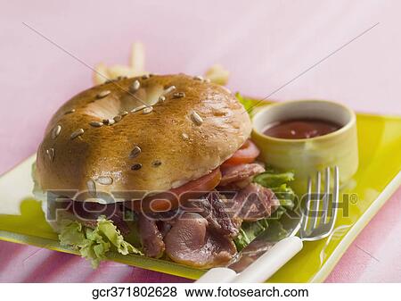 Stock Photo - Close-up of a bacon bagel. Fotosearch
