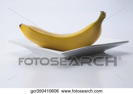 Stock Photograph - Close-up of a banana on a plate. Fotosearch